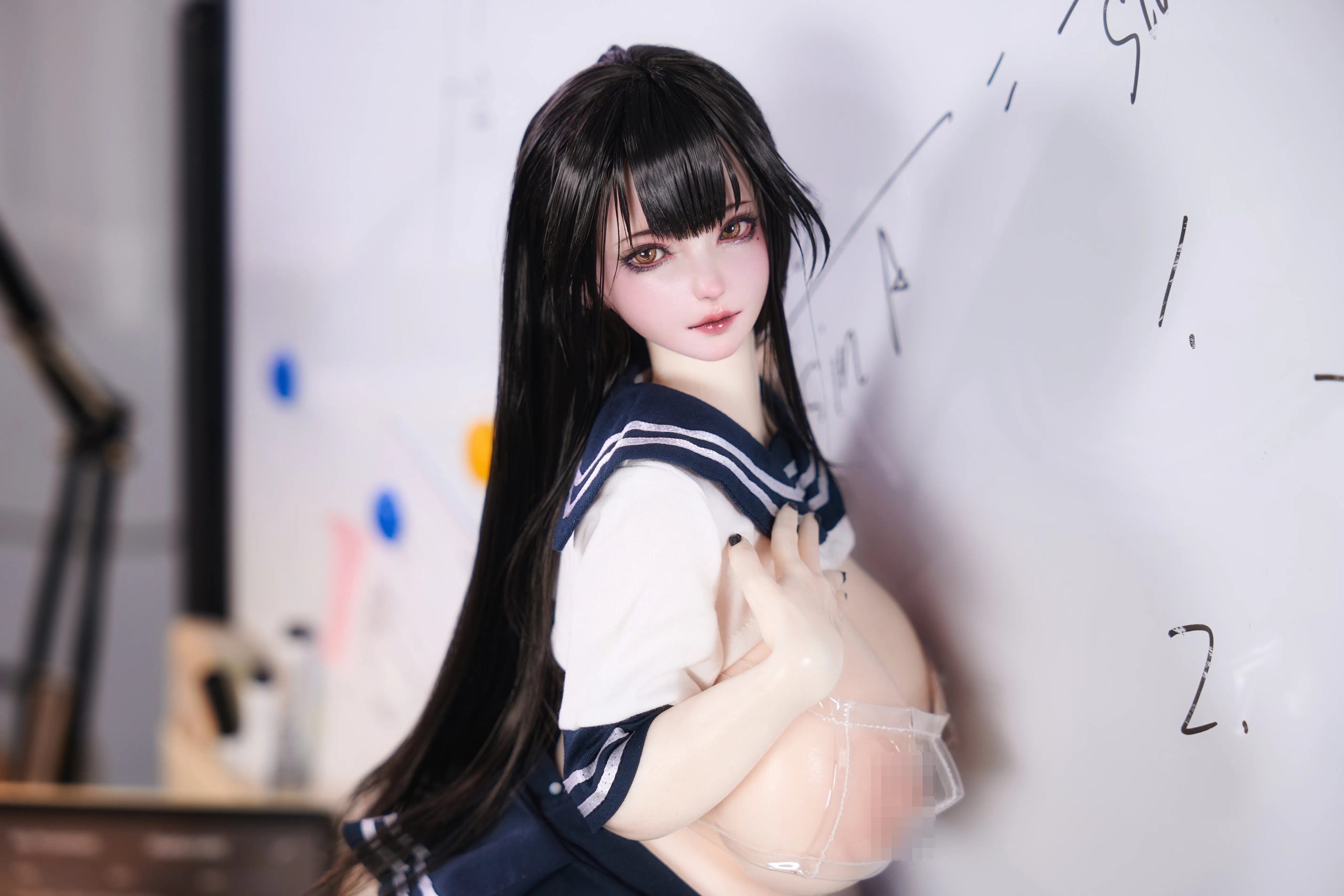 Miyu mini silicone anime sex doll seated on a desk with black thigh-high stockings